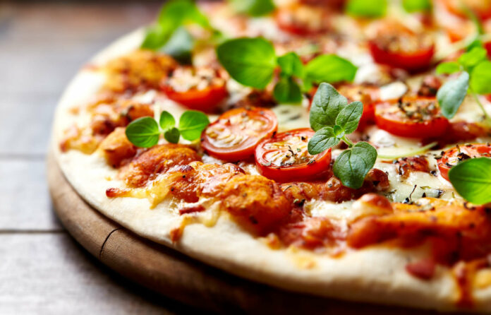Tasty vegetarian pizza with cherry tomatoes, mozzarella chee