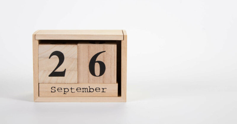 Wooden calendar September 26 on a white background