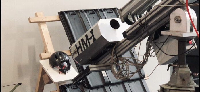 Hans Starl demonstriert den Beschuss von Dachziegeln mit Eiskugeln, wobei ein Fahrradhelm (kl. Foto) einem sechs Zentimeter großen Geschoß nicht mehr standhält.