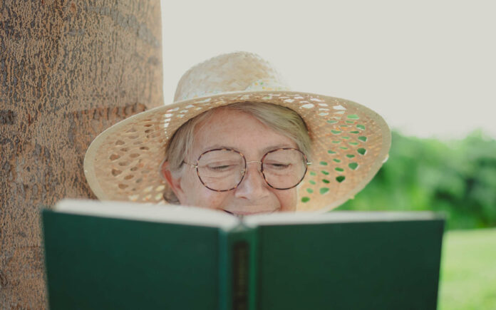 Portrait of relaxed attractive senior woman with hat and eye