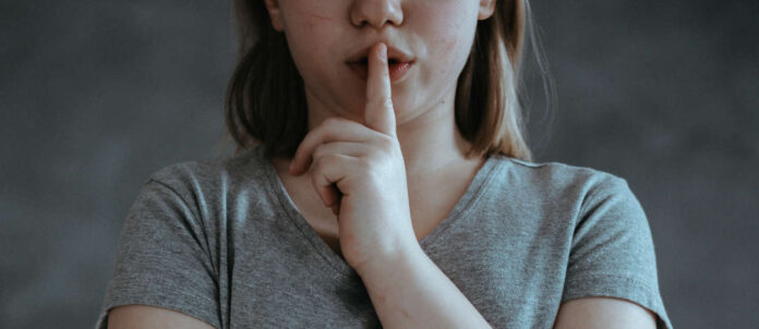 Girl with finger on mouth