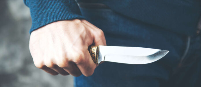 man hand knife on dark background