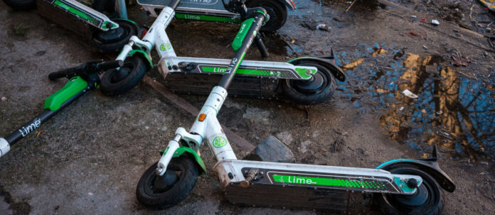 Electronic scooter or E-Scooter of the company Lime laying o