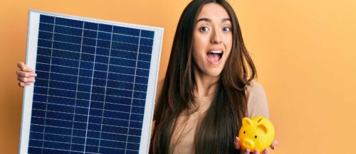 Young hispanic girl holding photovoltaic solar panel and pig