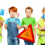 Group of four kids studying road safety rules