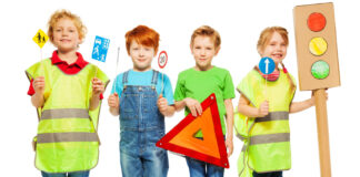 Group of four kids studying road safety rules