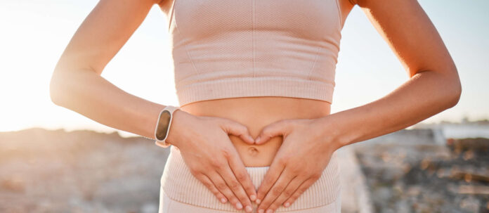 Woman, heart and hands on stomach for fitness, weightloss di