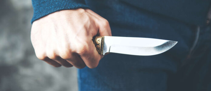 man hand knife on dark background
