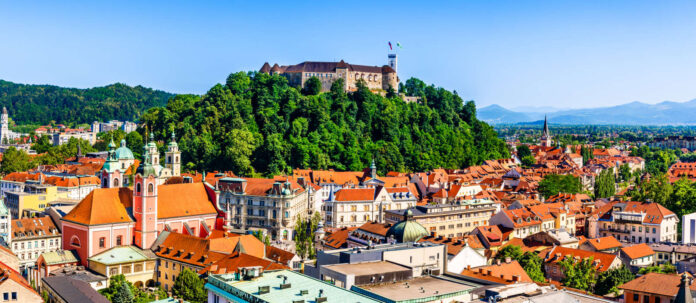 Old town and the medieval Ljubljana castle on top of a fores