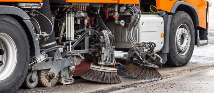 Car cleans city Road. Washing Road concept. Sweep Machine Cl