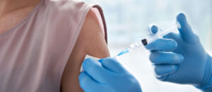 Male doctor making covid 19 vaccination injection in shoulde