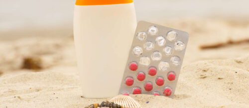 Shells, lotion and pills of vitamin E, seasonal concept